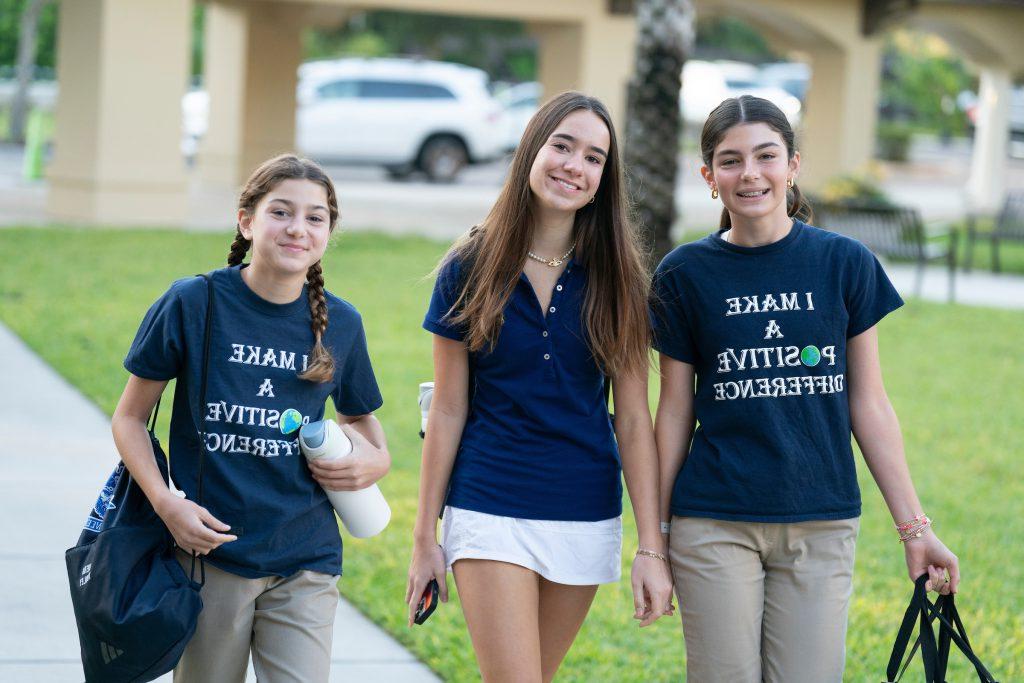 Three private middle school girls walking on the quad on campus in Tampa on a gorgeous day